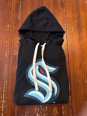 Black Pullover Hoodie with Cream Drawcords and Subtle Tag